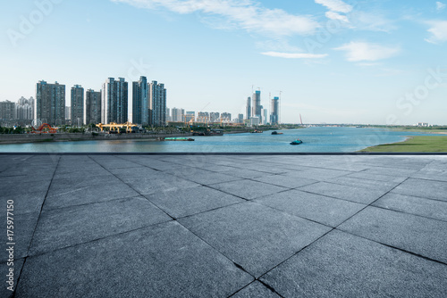 empty marble floor and cityscape of nanchang in blue cloud sky