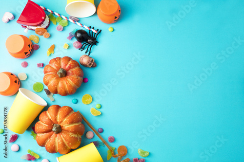 colorful party halloween with decor and dessert candy sweet on blue background top view