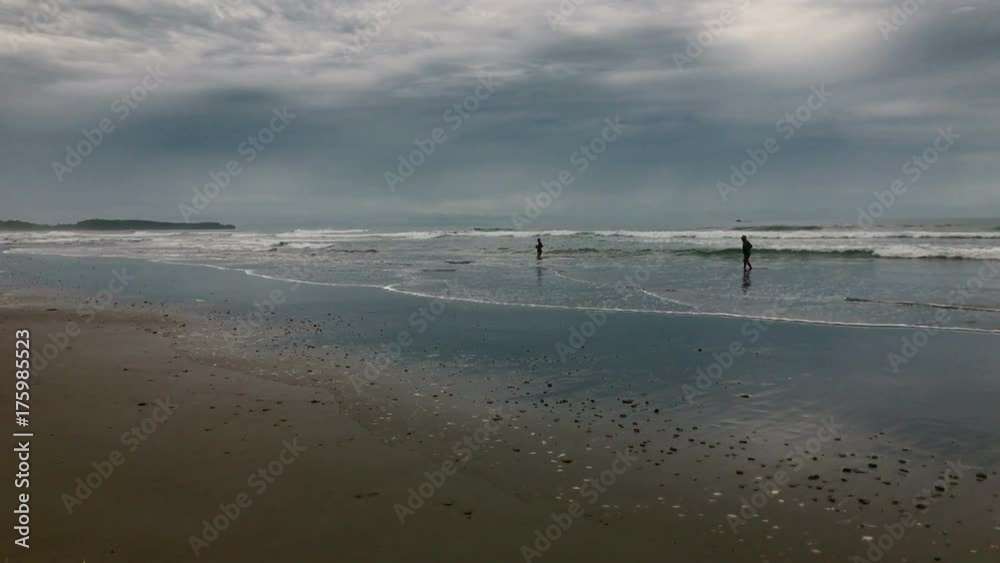Old man walking on the beach. Senior adult man walking on water by the shore. Old man walking on the beach. Senior adult man walking on water by the shore.