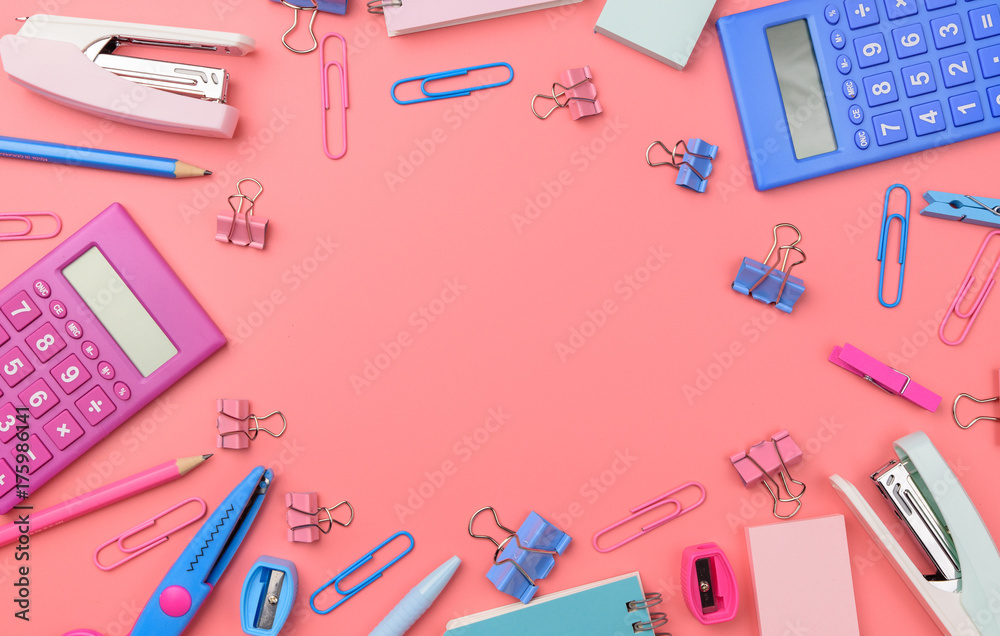 Stationary concept, Flat Lay top view Photo of Scissors, pencils, paper clips,calculator,sticky note,stapler and notepad in pink and blue tone on pink background with copy space Stationary concept, Flat Lay top view Photo of Scissors, pencils, paper clips,calculator,sticky note,stapler and notepad in pink and blue tone on pink background with copy space