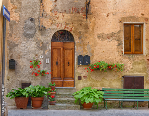Fototapeta Naklejka Na Ścianę i Meble -  Traditional façade of Italian house in the small magical and old village of Pienza, Val D'Orcia Tuscany – Italy
