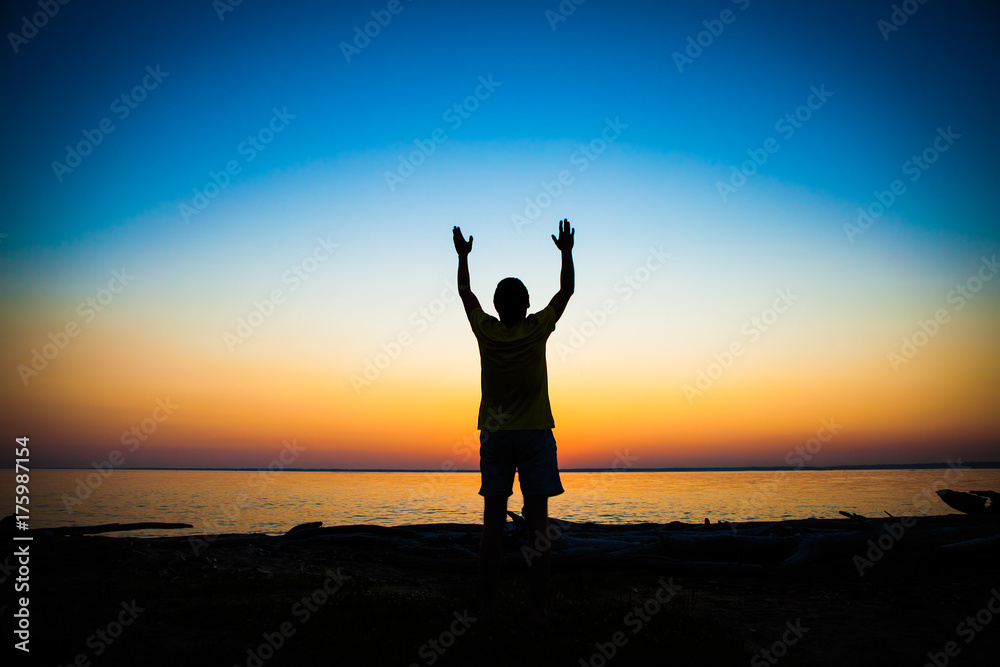 Fototapeta premium Person Praying at Sunset