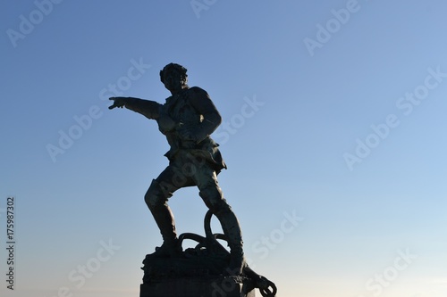 Statue of Robert Surcouf (1773 – 1827) pointing to the ocean, in Saint Malo, Brittany, France