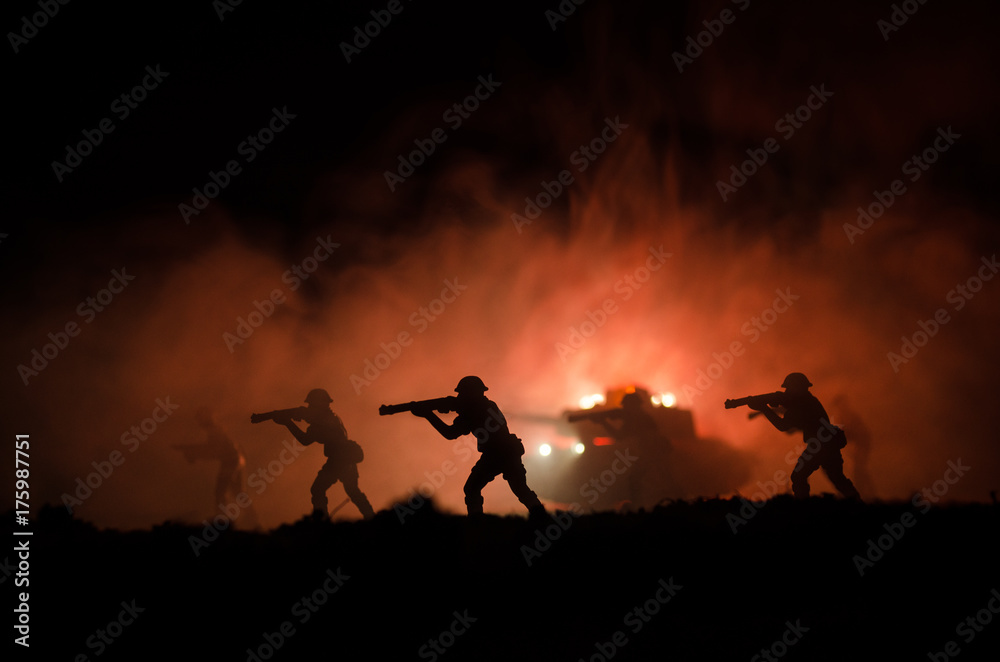 Obraz premium Military silhouettes of soldiers against the backdrop of dark foggy sky. Battle scene with explosion and burning clouds behind fighing soldiers. Toy decoration