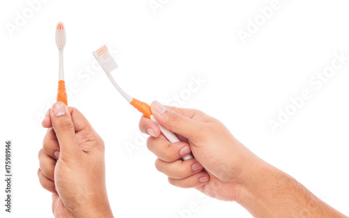 male hand holding toothbrush