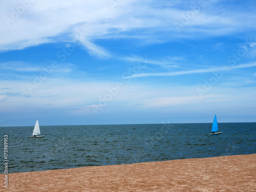 Sailboat blue and white with sky blue sea