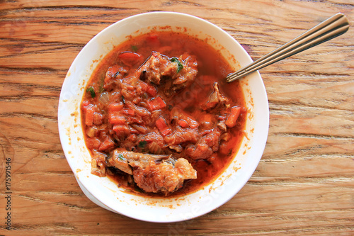 Chakhokhbili - traditional Georgian dish. Chicken stewed with tomatoes photo