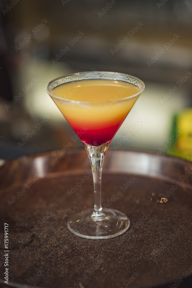 Colorful cocktail, yellow rainbow kind with juice and vodka Colorful cocktail, yellow rainbow kind with juice and vodka