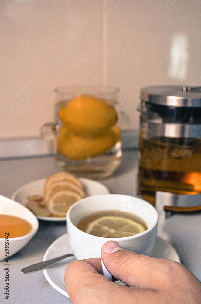 A man is holding cup of tea A man is holding cup of tea