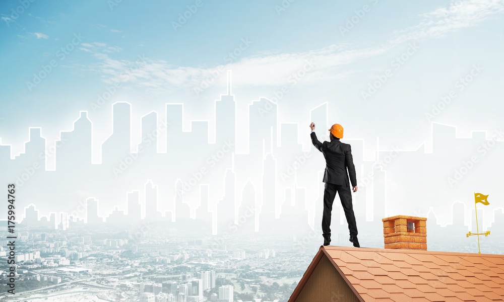 Man architect draw silhouette of modern city on blue sky. Mixed media Man architect draw silhouette of modern city on blue sky. Mixed media