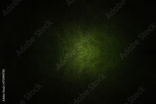 Green background or green Christmas paper with bright spotlight on black background texture for Christmas cards or background © teerapong