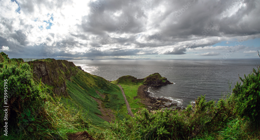 Landscape of Giant's Causeway trail with a blue sky in summer, Co. Antrim, tourism in Northern Ireland in United Kingdom. UNESCO heritage.