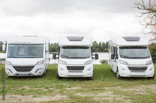 three caravan camper motorhome of face in an exhibition or a garage of hiring