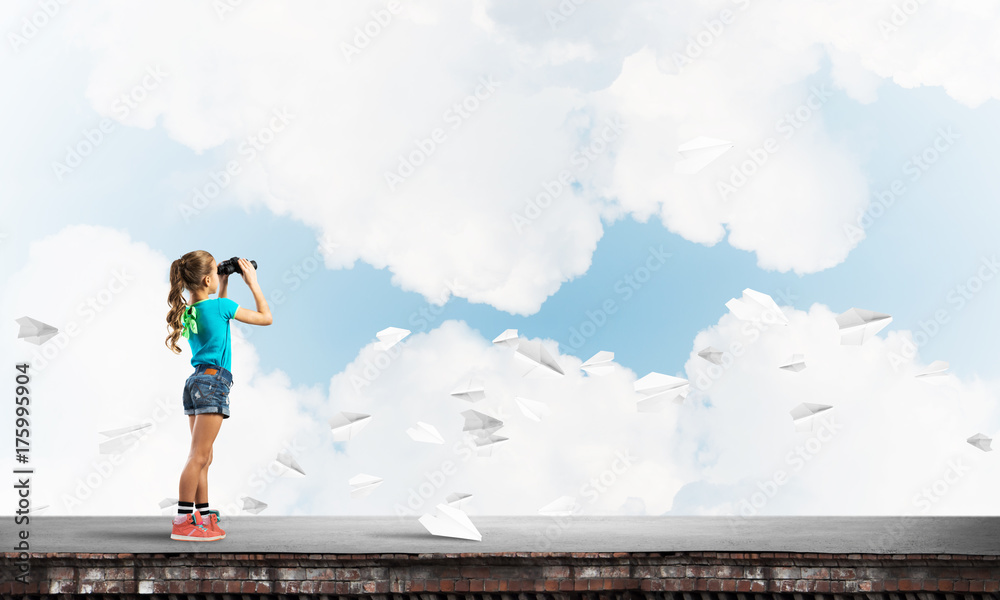 Concept of careless happy childhood with girl of school age looking in future Concept of careless happy childhood with girl of school age looking in future
