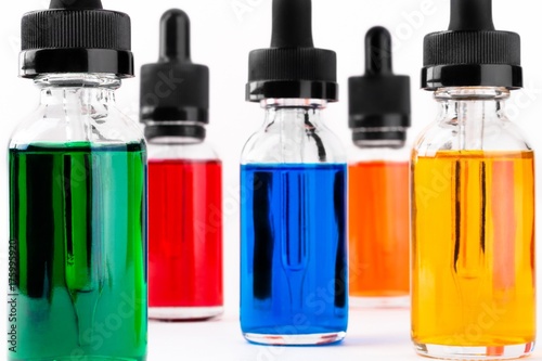 transparent glass bottles filled colored liquid with dropper