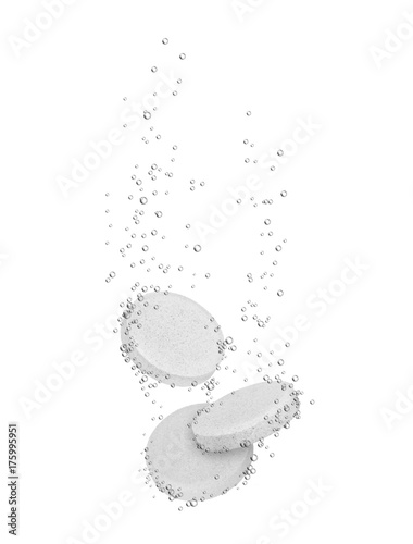 Three medical pills dissolves in water, isolated on white background