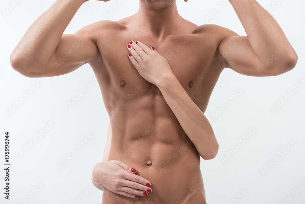 Charming guy is standing with raised arms