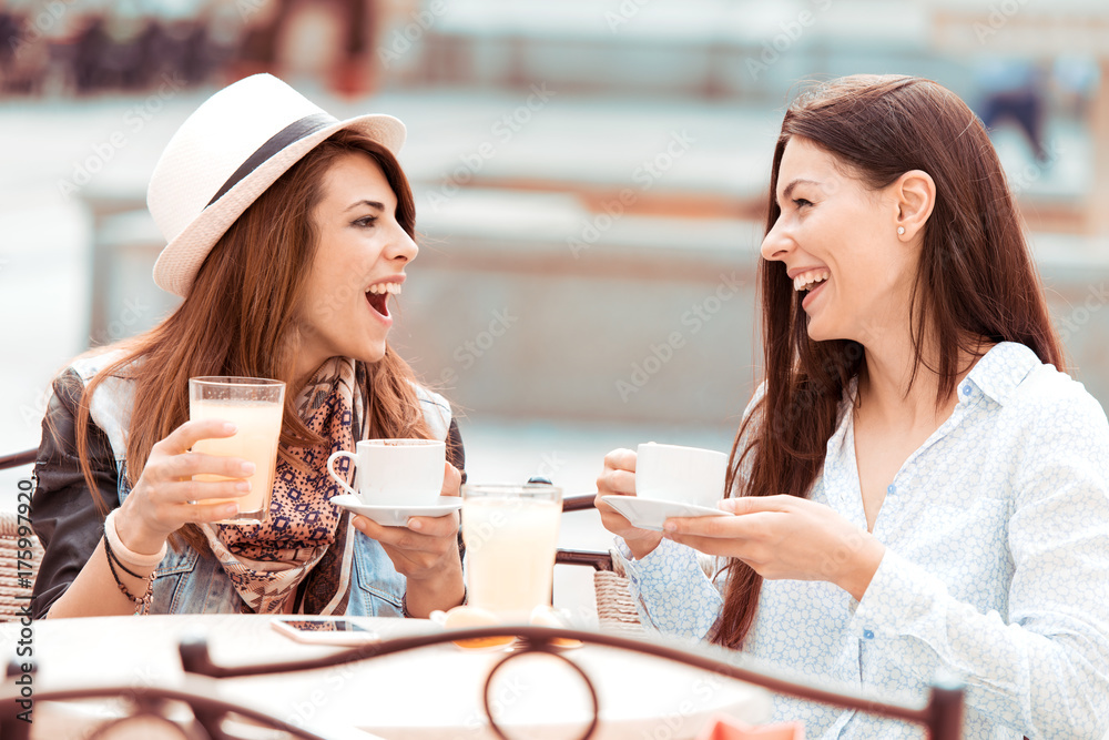 Two young women with great smile and hairstyle sitting at a bar Two young women with great smile and hairstyle sitting at a bar