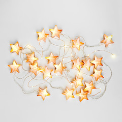 Abstract star shaped Christmas lights background. Flat lay, top view