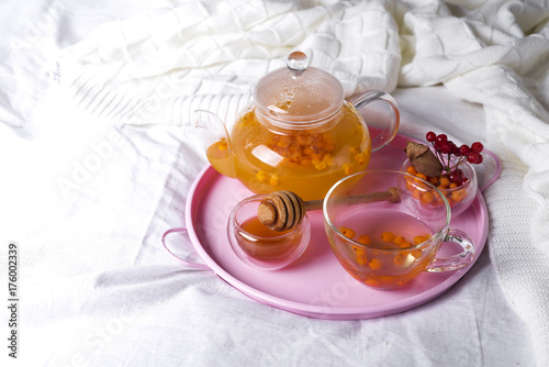 A cup of tea with sea buckthorn and herbs