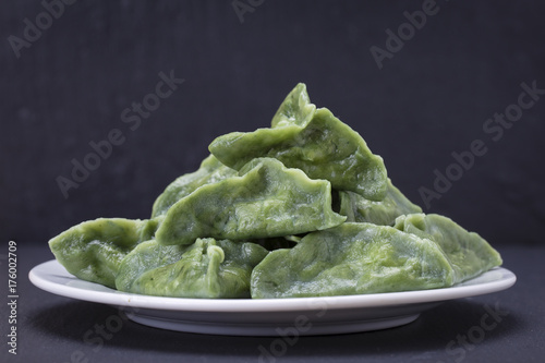 Green dim sum, chinese food. Dumplings with beef meat or mashed potatoes or cottage cheese in the dough with spirulina