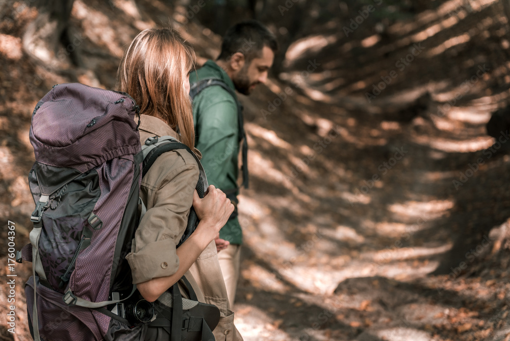 Active married couple walking in the woods