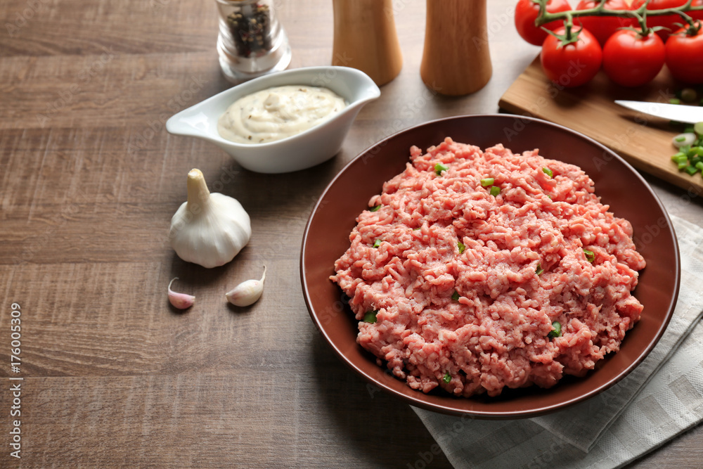 Plate with fresh raw minced meat on table Plate with fresh raw minced meat on table