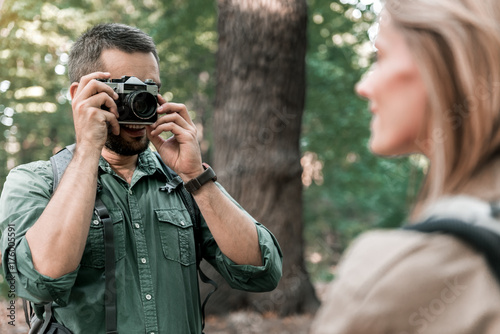 Happy loving couple using camera in the nature