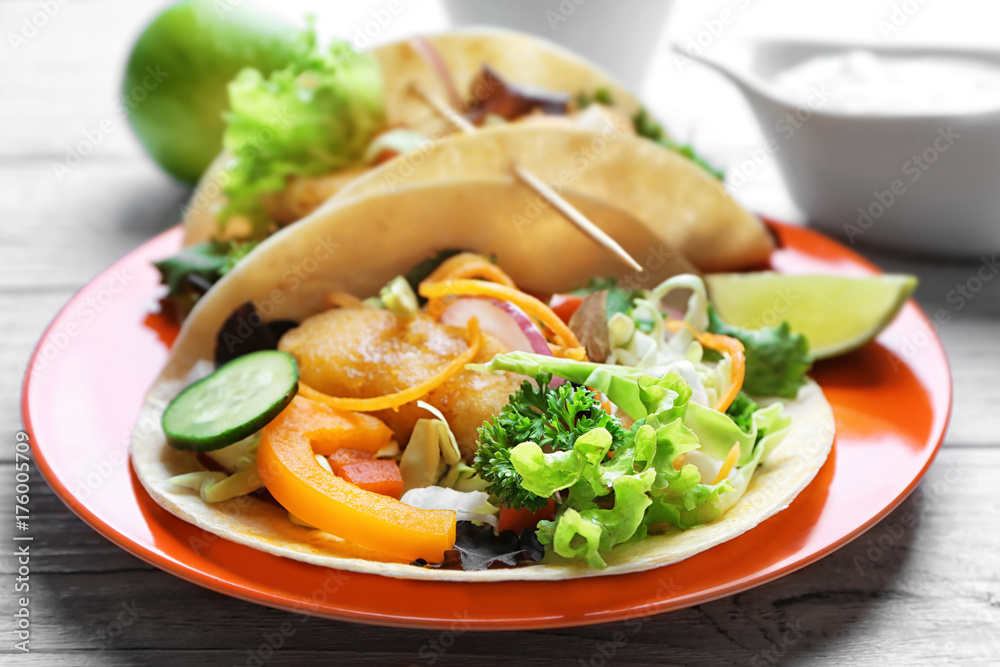 Plate with delicious fish tacos on table, closeup Plate with delicious fish tacos on table, closeup