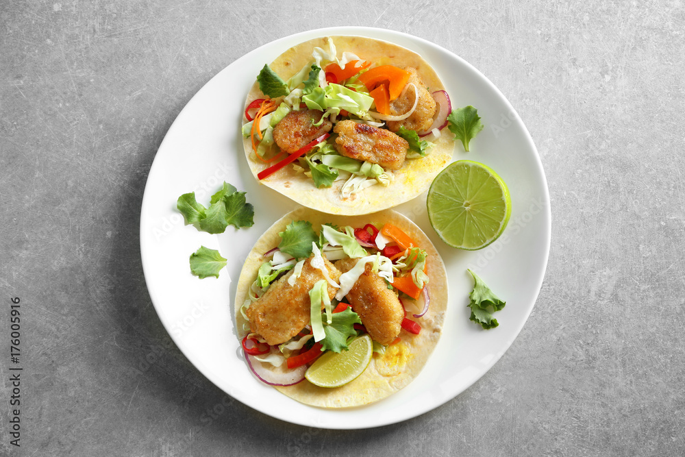 Plate with delicious fish tacos on table Plate with delicious fish tacos on table