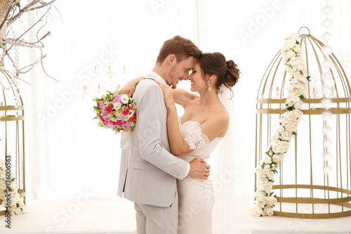 Happy beautiful couple on wedding day, indoors