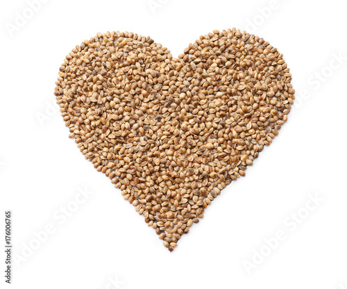 Heart made of hemp seeds on white background