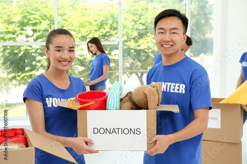 Two happy teen volunteers h...