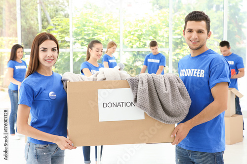 Two happy teen volunteers h...