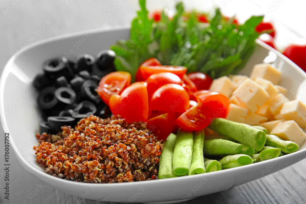 Plate with quinoa and vegetables on table, closeup