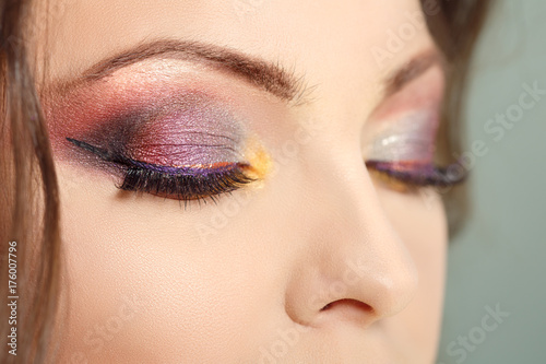 Eye makeup close-up. Bright professional makeup. Presentation of cosmetic products, eye shadow, mascara and eyebrows.