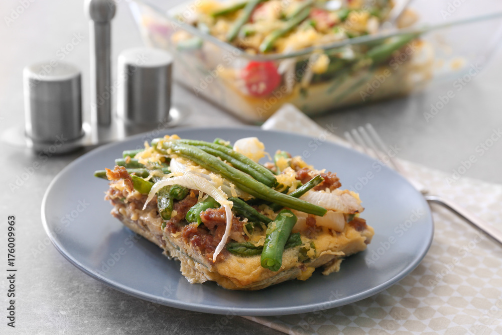 Plate with delicious green bean casserole on kitchen table Plate with delicious green bean casserole on kitchen table