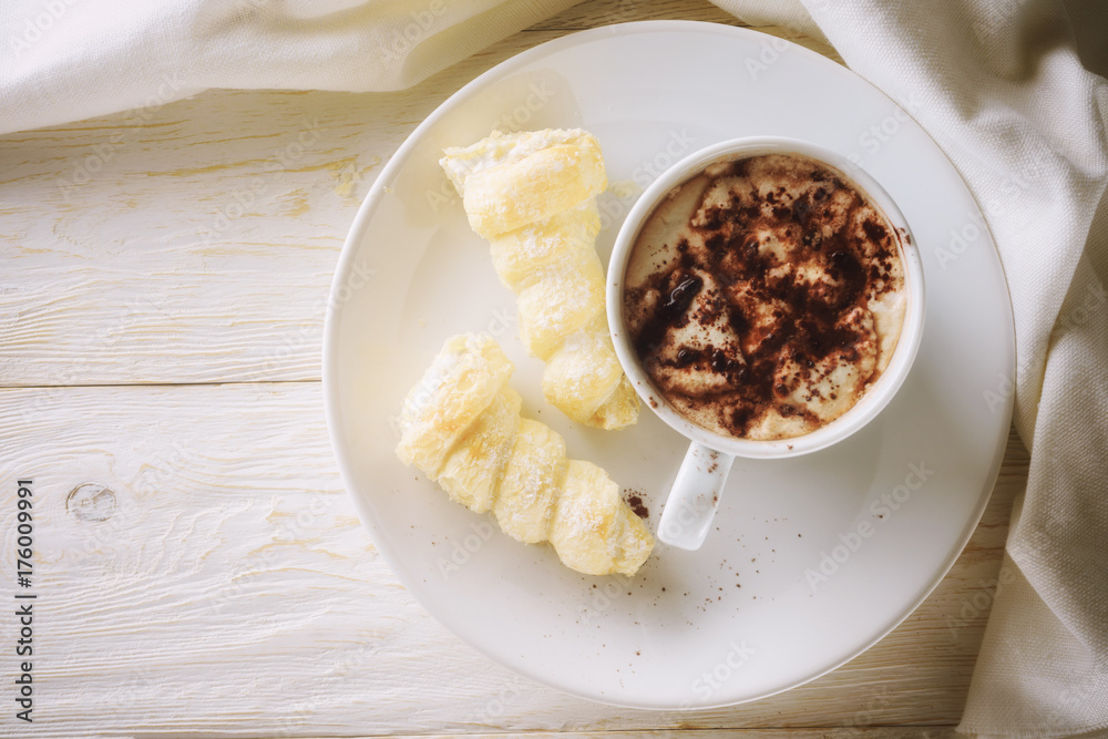 Cup of hot cocoa and cream cakes Cup of hot cocoa and cream cakes