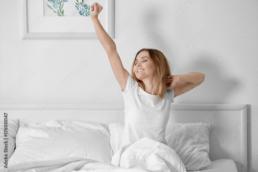 Young beautiful woman awaking in light room Young beautiful woman awaking in light room