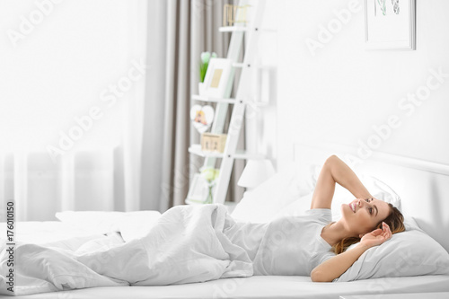 Young beautiful woman awaki...