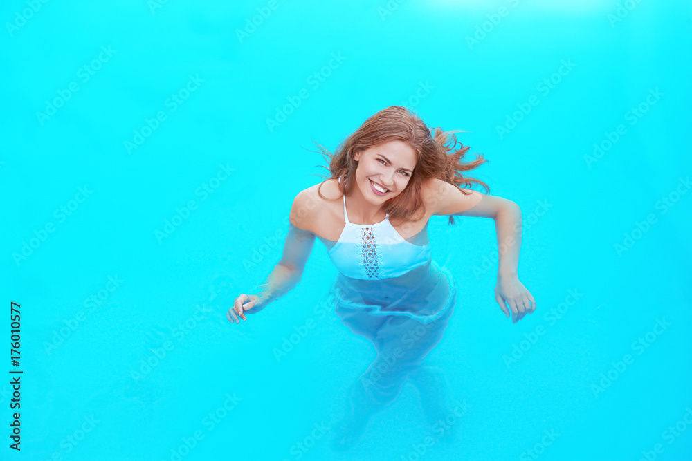 Beautiful young woman in swimming pool