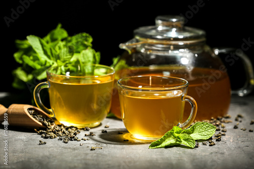 Cups of mint tea on table