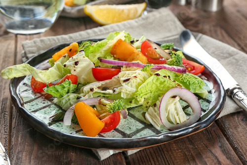 Dish with kale salad on table, closeup