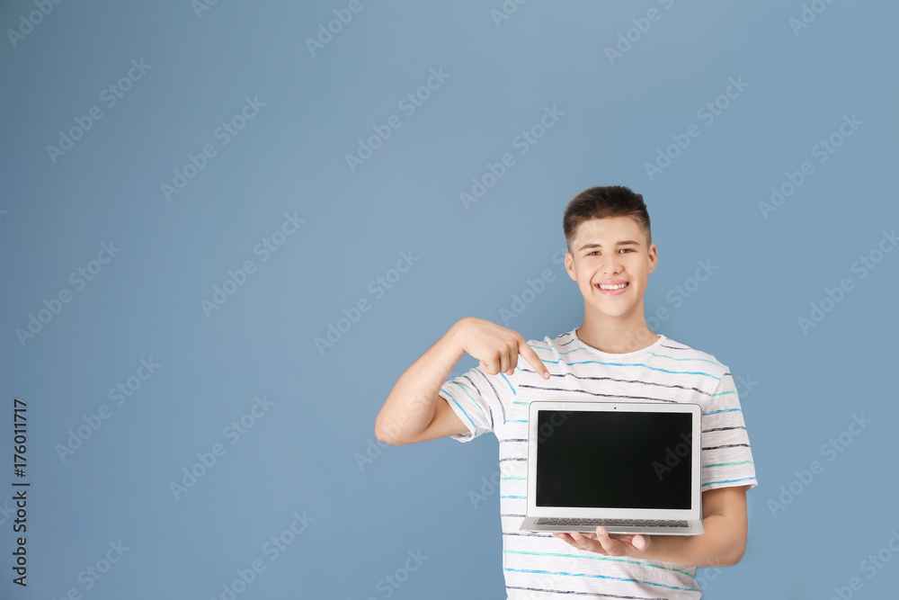 Εκτύπωση καμβά Teenager boy with laptop on color background