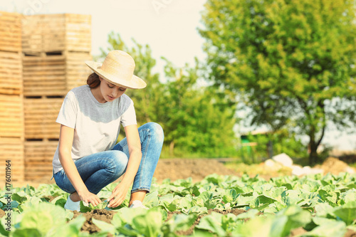 Young female farmer working in field