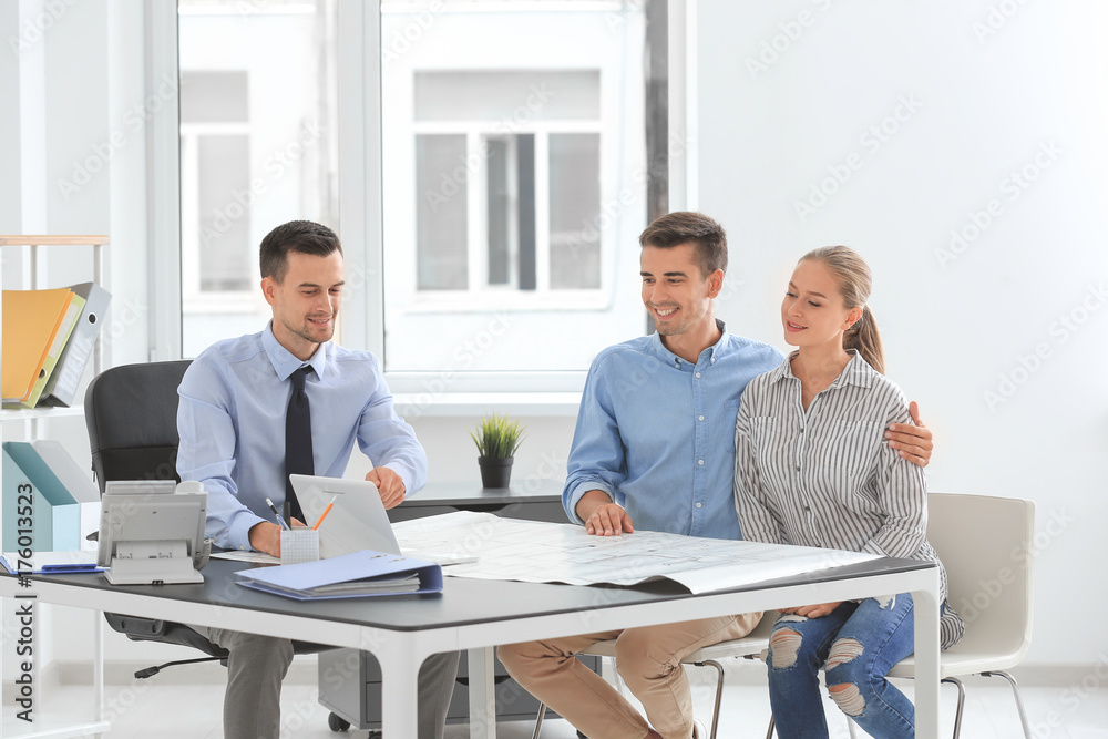 Real estate broker and customers discussing project of new flat Real estate broker and customers discussing project of new flat