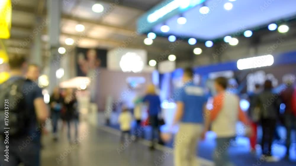 Abstract Defocused Blurred Background flow of many people inside space shopping center or mall, exhibition, exposition, hall real time.
