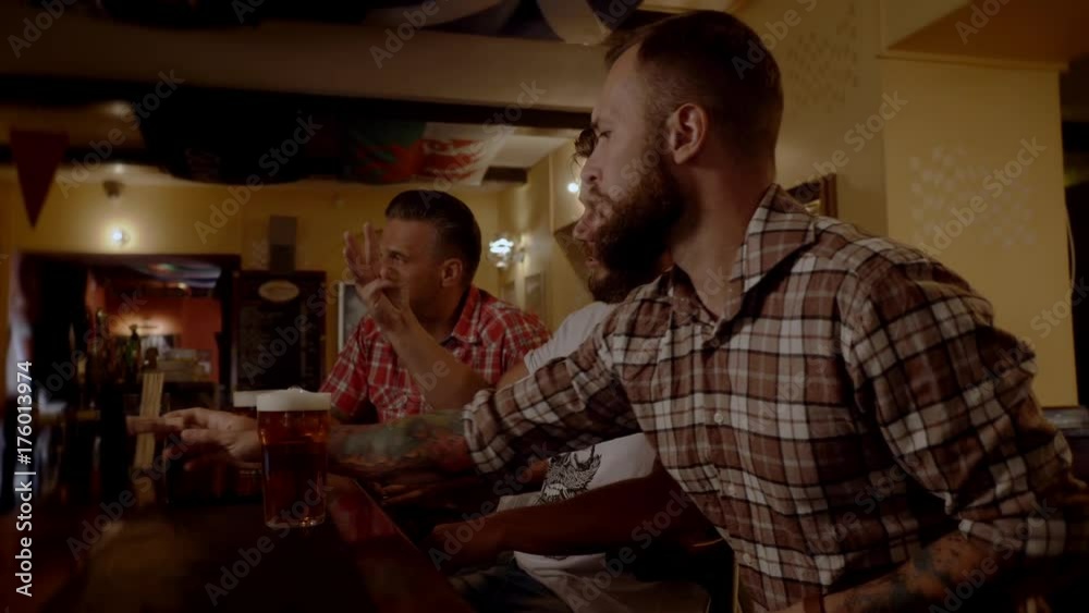 Good old friends drinking beer in a pub Good old friends drinking beer in a pub