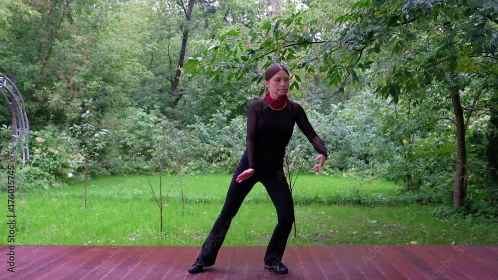Woman doing Qigong in the park. Slow motion Stock Video Adobe Stock