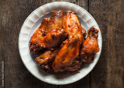 A plate of smoked bbq chicken wings with candied bbq sauce